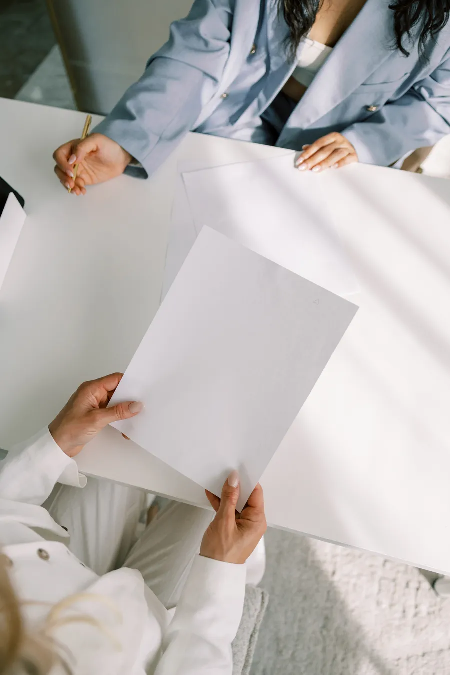 Two people at a table reviewing plans