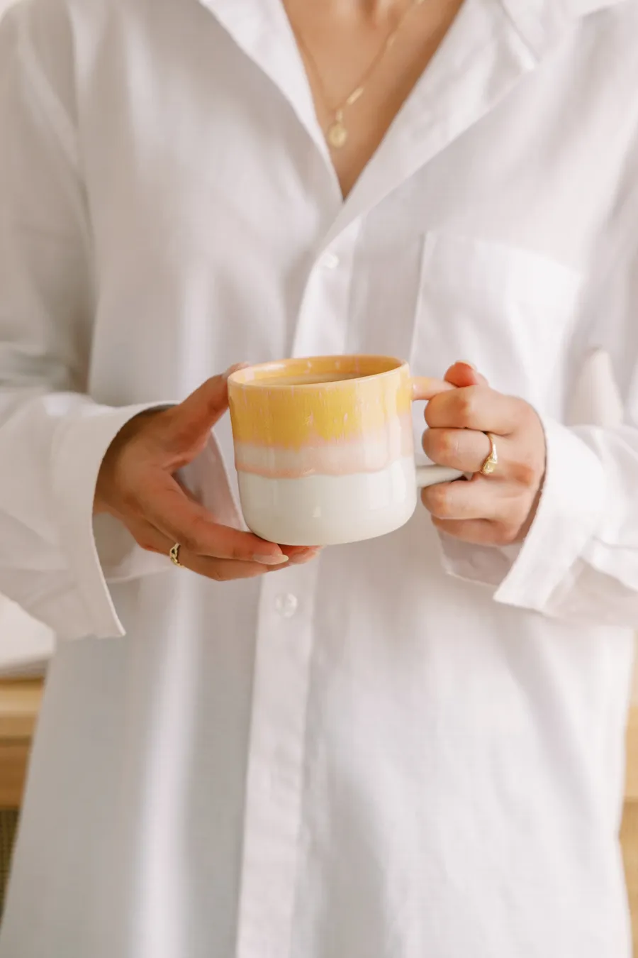 A hand holding a coffee mug, a calm moment
